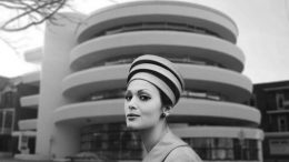 Une femme portant un chapeau devant la Caisse Desjardins sur la rue des Érables.